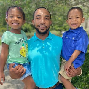 Chase Flowers, LAH Real Estate Hoover Agent, posing with his children.